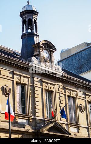 Elegant old Parisian architecture with the French flag on the facade Stock Photo