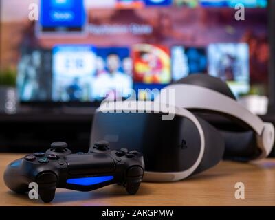 UK, Jan 2020: Virtual reality VR Sony headset for Playstation with Dualshock remote controller in home setting