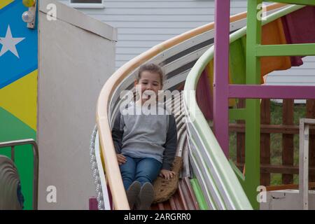 A girl on a Helter Skelter Stock Photo