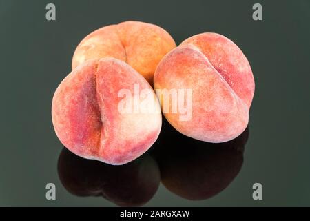 Fresh Peaches on reflective surface. Stock Photo