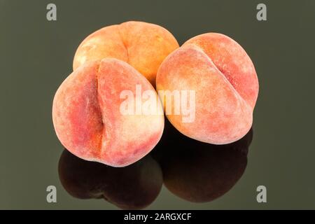 Fresh Peaches on reflective surface. Stock Photo