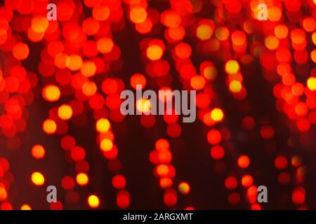 Abstract festive background of red blurry garland lights Stock Photo