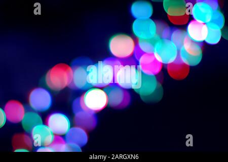 Blurry garland lights diagonal on dark for concept or new year holidays design Stock Photo