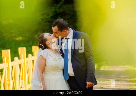 Young wedding couple walking on field. Lutsk Ukraine 10.06.2019 Stock Photo