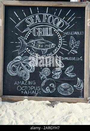 A Seafood Grill Menu on a Chalkboard. Stock Photo