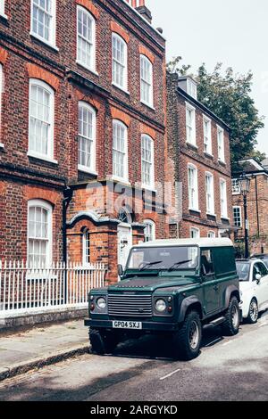 London/UK - 17/07/2019: dark green Land Rover Defender parked on a side of the road in London. British four-wheel drive off-road vehicle developed in Stock Photo