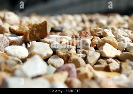 Small stones, gravel or pebbles close up from ow angle with perspective view Stock Photo