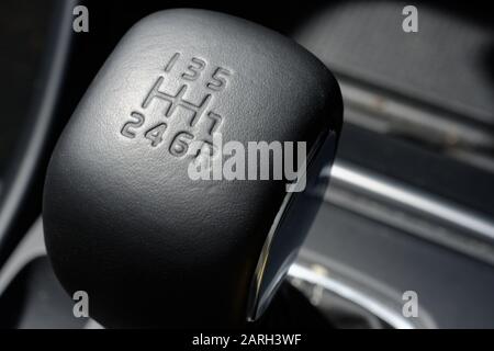 Car gear stick. Manual gear shifter with leather top impressed with the gear positions. Leather gear knob showing where the gears are located. Stock Photo