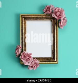 Empty antique photo frame with rose decoration on green background Stock Photo