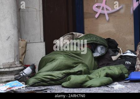 A homeless man sleeping in the doorway of closed down branch of the Leeds Building Society on Kingsway, Holborn, London. PA Photo. Picture date: Tuesday January 28, 2020. Photo credit should read: Victoria Jones/PA Wire Stock Photo