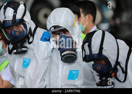 Crew members wearing protective suits and mask during the disinfection process.Thai Airways International spray disinfectant on passenger seats all plane following a risky corona virus infection. Thailand has detected 14 cases, Thai health officials are stepping up monitoring and inspection. The virus has so far killed at least 106 people an outbreak which began in the Chinese city of Wuhan. Stock Photo