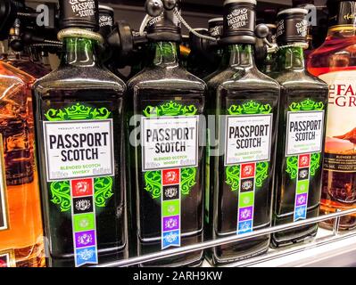 Samara, Russia - January 25, 2020: Passport blended scotch whiskey ready for sale on the shelf in superstore. Various bottled alcoholic beverages and Stock Photo