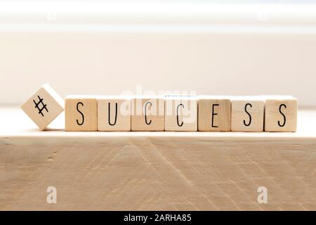 Hashtag with succes written wooden cubes, social media concept Stock Photo