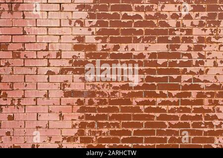 a faded red painted brick wall Stock Photo