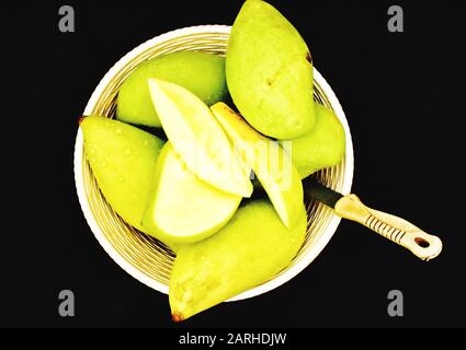 Green mangoes in a Basket Stock Photo