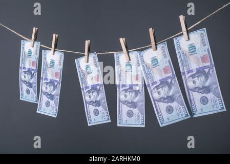 Money Laundering concept. US dollars hung out to dry and clean Close-up of money, dried on the ropes, fastened with clothespins. The concept of drying Stock Photo