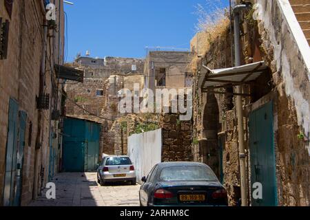 Automobiles parked in an ancient town Stock Photo