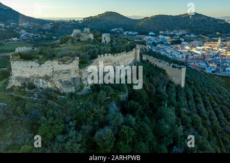 Aerial view of Corbera medieval Gothic castle in ruins on a hilltop near the coast with walls and a standalone tower in Spain Stock Photo