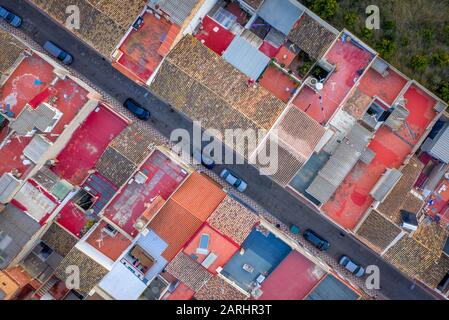 Colorful orange, red, gray, blue rooftops from above in Corbera Spain Stock Photo