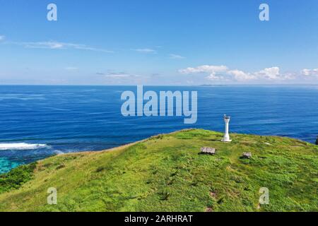 Lighthouse on a tropical island. Beautiful landscape with a green island. Basot Island, Caramoan, Camarines Sur, Philippines. Stock Photo