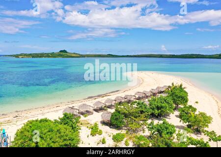 Tropical island with palm trees and a white sandy beach. Caramoan Islands, Philippines. Beautiful islands, view from above. Summer and travel vacation concept. Cotivas Island Cottage. Stock Photo