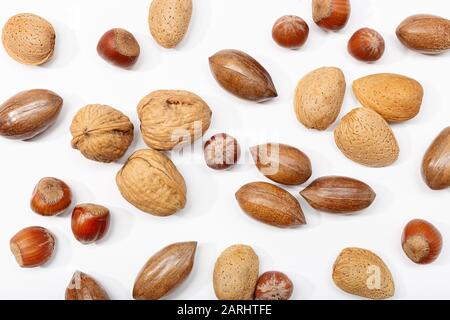 Background of a variety of nuts isolated on white background. Healthy food backdrop Stock Photo