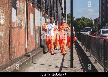 London/UK-22/07/19: Crossrail construction workers walking along the street. Crossrail Limited is the company that has been set up to build the new ra Stock Photo