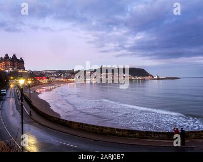 View across South Bay towards Castle Hill at dusk Scarborough North Yorkshire England Stock Photo