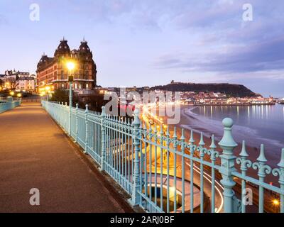 View over South Bay towards Castle Hill from Spa Bridge and The Grand Hotel at dusk Scarborough North Yorkshire England Stock Photo