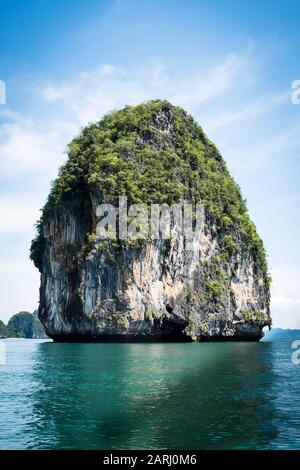 Thai Karst Water Rock Formations reflecting in the waters of Phang Nga Bay, east of Krabi Thailand. Beautiful sheer stone faces, Karst is a topography Stock Photo