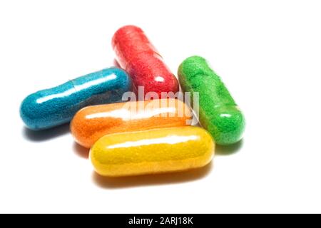 Multi-colored capsules vitamins close up isolated on a white background Stock Photo