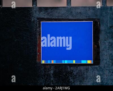 Box real sign on wall of building. Dark blue rectangular signboard of cafe, restaurant or shop on city street on wall of old mansion or stone building Stock Photo