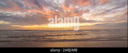 Panorama of colorful clouds over sea at sunset Stock Photo