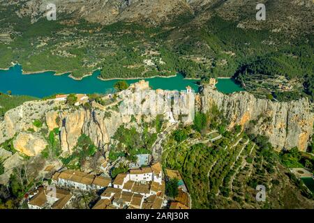 Aerial view of El Castell de Guadalest and Benimantell castle near Alicante Spain, popular tourist destination in the mountains above water reservoir Stock Photo