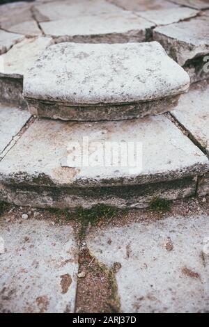 several steps of an old and ruined vintage staircase made of white stone Stock Photo