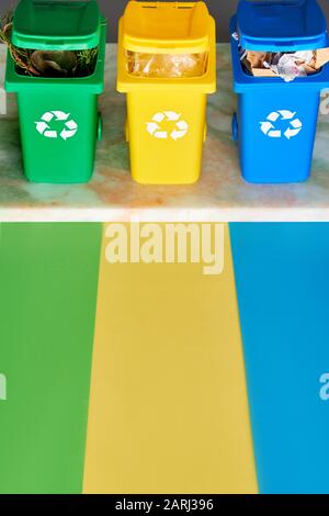 Three color-coded waste bins for trash, compostables and recycle lined ...
