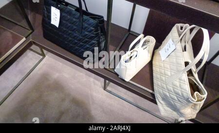 Luxury branded leather bags and shoes in famous shopping windows and stores in Milano, Italy Stock Photo