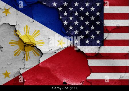 flags of Philippines and USA painted on cracked wall Stock Photo