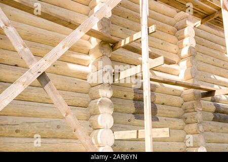 Fragment of new wooden house made from round logs. Stock Photo