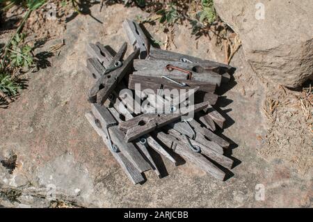 Pile of weathered wooden laundry clamps closeup Stock Photo