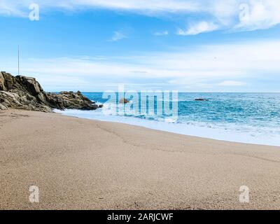 abstract background of sea waves, on golden sand, white sea foam. Stock Photo