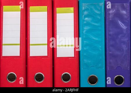 row of folders for papers and documentation on a shelf in the office Stock Photo