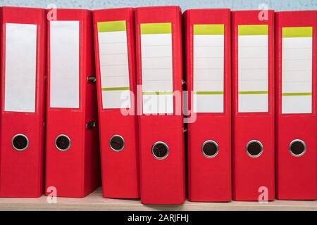 row of folders for papers and documentation on a shelf in the office Stock Photo