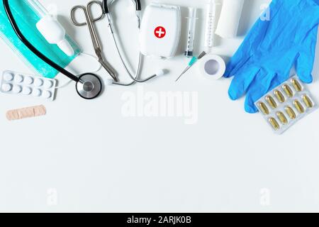 Medical equipments with stethoscope, scissors, syringes and other objects on blue background top view. Copy space. Stock Photo