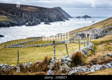 The ruins of an old famine stone built cottage on a remote part of the Irelands west coast in County Donegal Stock Photo