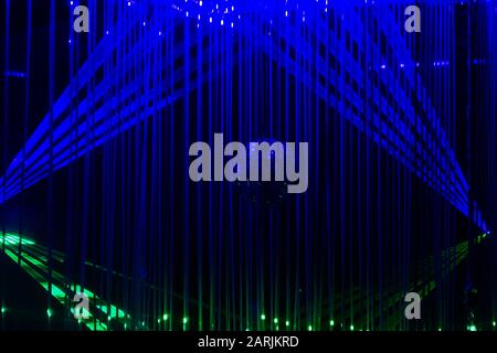 Green and blue laser beams on black background. Laser show rays stream Stock Photo