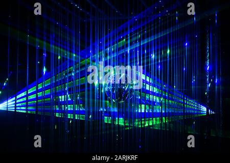 Green and blue laser beams on black background. Laser show rays stream Stock Photo