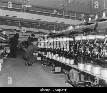 In the war-torn city of Arnhem, hard work is being done to build the art silk industry. This product so important for Dutch textile supply is manufactured here at the A.K.U. (Arnhem Kunstzijde Union). Spinning the yarns for shipping Annotation: Old number 902-1864 Date: 28 May 1947 Location: Arnhem Keywords: Industry, Textile Industry Stock Photo