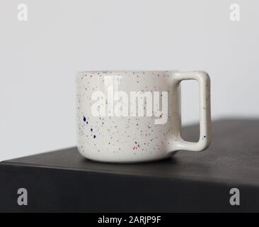 Beautiful handmade ceramic cup on black deck Stock Photo