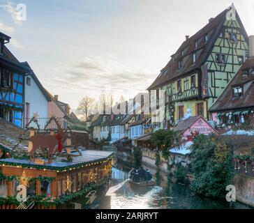 A boat in the small Venice in Colmar on Christmas days among the half-timbered houses Stock Photo